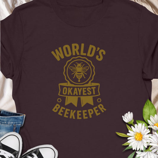 Celebrate your love for beekeeping with a humorous twist in this "World's Okayest Beekeeper" T-Shirt. Perfect for backyard beekeepers, honey lovers, and bee enthusiasts who know it's not about perfection—it's about passion. Makes a great gift for bee dads, moms, hobbyists, and anyone who keeps buzzing through life.
