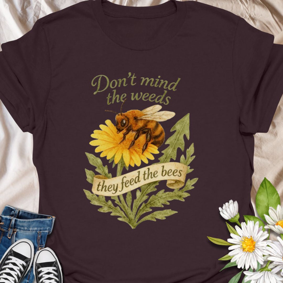 Support pollinators in style with this charming “Don’t Mind the Weeds, They Feed the Bees” t-shirt. Featuring a hand-drawn bee and dandelion artwork, this eco-friendly message tee is perfect for gardeners, nature lovers, and bee advocates who know weeds can be beautiful too.