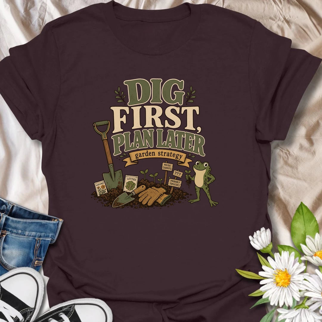 A funny gardener T-shirt for anyone whose garden strategy begins with digging and develops from there. The vintage-style design features a frog, shovel, gardening gloves, seedlings, and slightly uncertain plant markers. A playful gift for vegetable gardeners, backyard growers, and spontaneous planting enthusiasts.