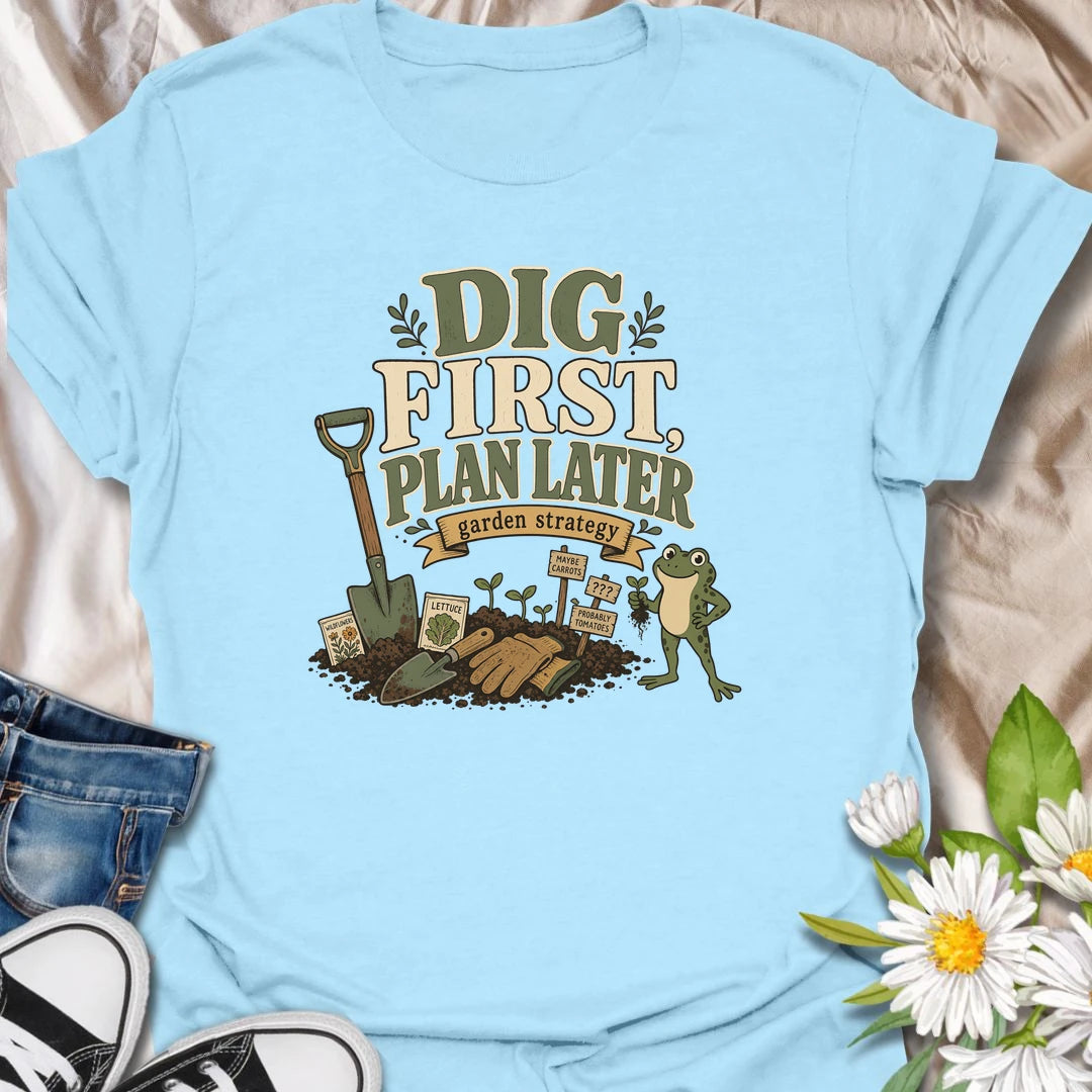 A funny gardener T-shirt for anyone whose garden strategy begins with digging and develops from there. The vintage-style design features a frog, shovel, gardening gloves, seedlings, and slightly uncertain plant markers. A playful gift for vegetable gardeners, backyard growers, and spontaneous planting enthusiasts.