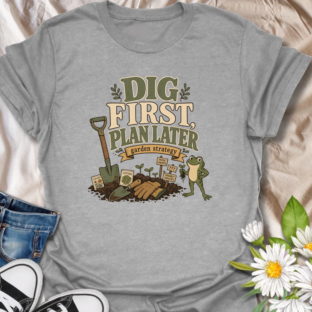 A funny gardener T-shirt for anyone whose garden strategy begins with digging and develops from there. The vintage-style design features a frog, shovel, gardening gloves, seedlings, and slightly uncertain plant markers. A playful gift for vegetable gardeners, backyard growers, and spontaneous planting enthusiasts.