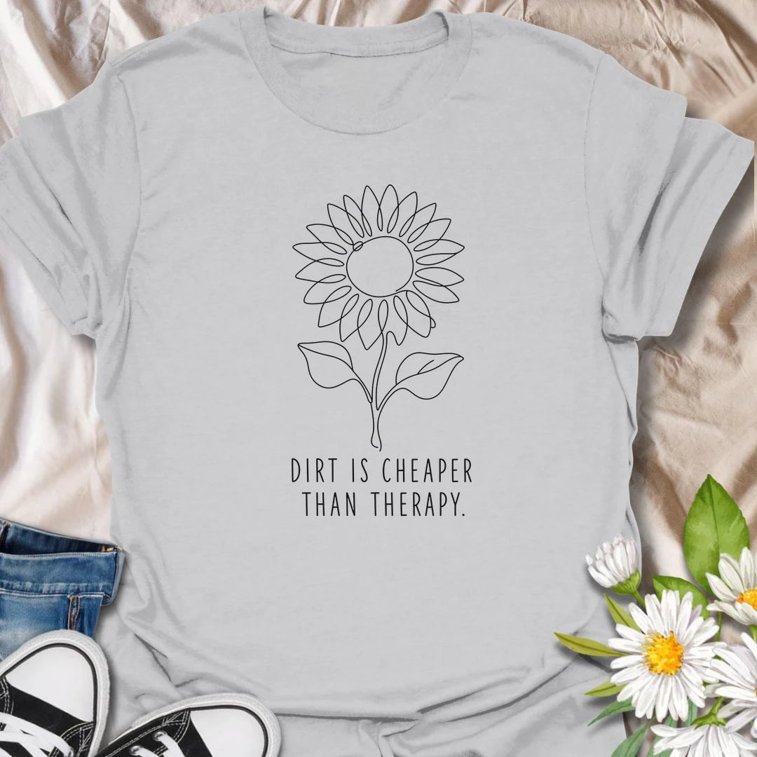 This Dirt Is Cheaper Than Therapy t-shirt is perfect for gardeners who know time in the soil can make everything feel a little better. Featuring a simple sunflower line-art design with a funny gardening phrase, this minimalist botanical tee is great for plant lovers, flower gardeners, backyard growers, and anyone who finds peace, calm, and joy in the garden.