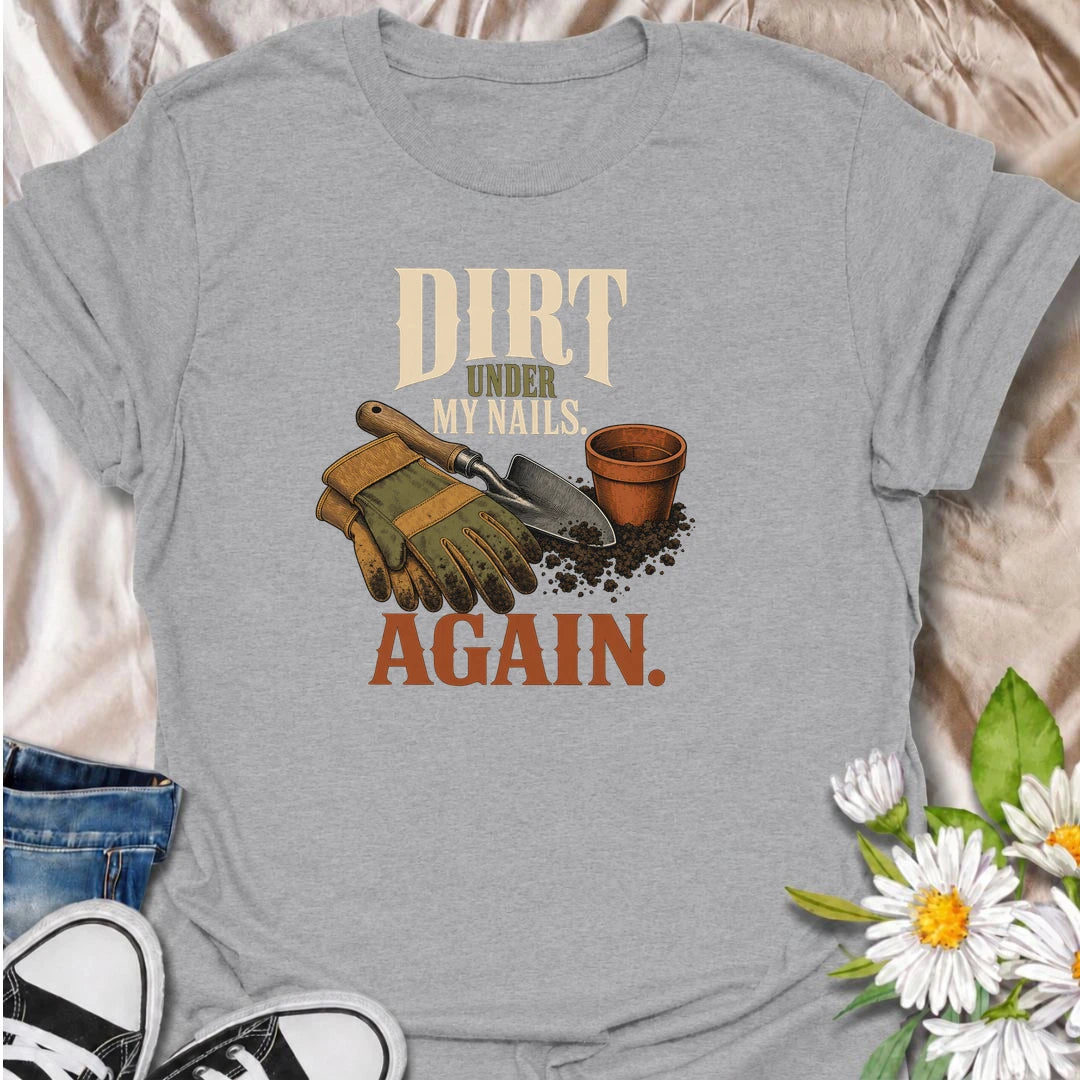 A funny gardening T-shirt for anyone who somehow ends up with dirt under their nails every time they step outside. Featuring garden gloves, a hand trowel, soil, and a terracotta pot, this design has a warm vintage gardening feel. The phrase “Dirt Under My Nails. Again.” is perfect for gardeners who know there is no such thing as a quick job in the garden. It makes a great gift for flower gardeners, vegetable growers, cottage gardeners, and anyone happiest with their hands in the soil. Ideal for garden days,