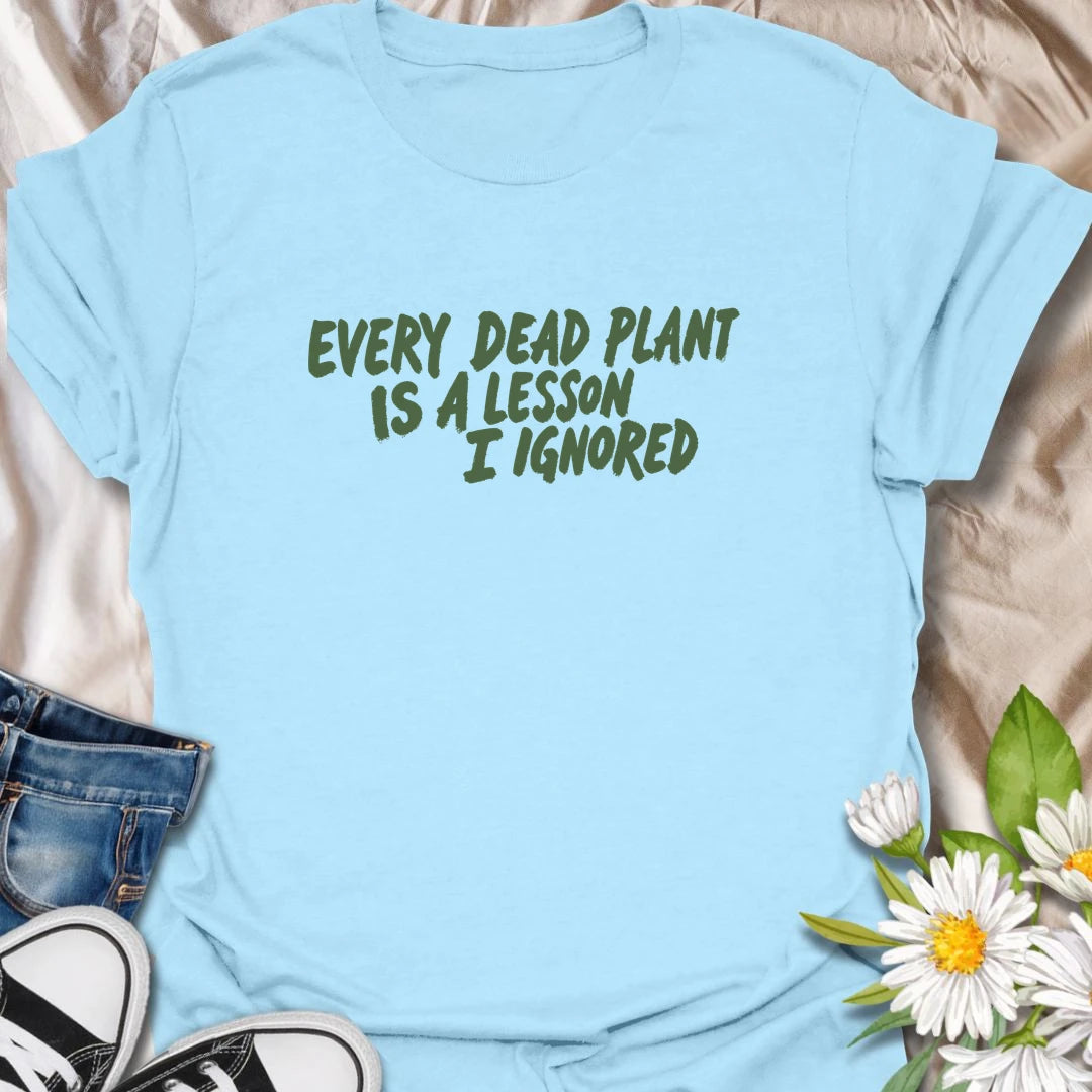 Funny plant t-shirt for anyone whose dead plants were definitely lessons… just not lessons they followed.
Features bold text-only styling with a relatable houseplant humor message for plant lovers and plant parents.
Perfect for houseplant owners, beginner gardeners, and anyone who laughs through the plant struggle.