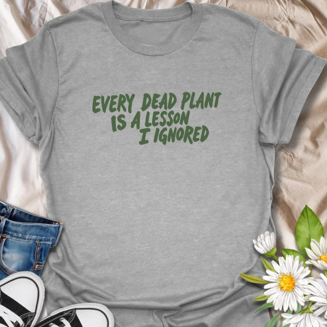 Funny plant t-shirt for anyone whose dead plants were definitely lessons… just not lessons they followed.
Features bold text-only styling with a relatable houseplant humor message for plant lovers and plant parents.
Perfect for houseplant owners, beginner gardeners, and anyone who laughs through the plant struggle.