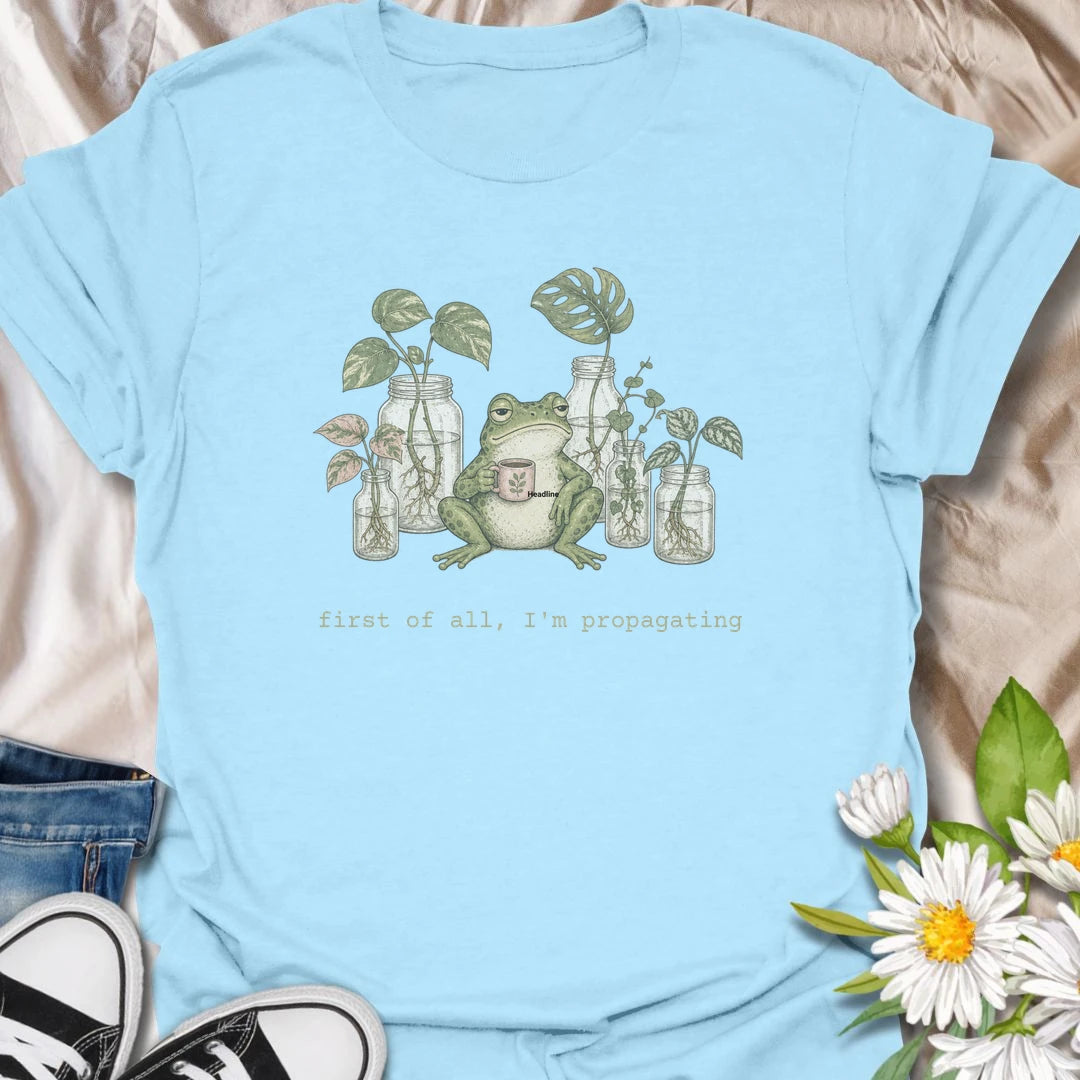 This First Of All, I’m Propagating t-shirt is perfect for plant lovers who are always snipping, rooting, and growing one more cutting. Featuring a relaxed frog holding a mug surrounded by propagation jars and trailing houseplants, this design blends cozy plant humor with a cottagecore botanical feel. Great for plant moms, plant dads, houseplant collectors, frog lovers, and anyone obsessed with propagating pothos, monstera, and indoor plants.