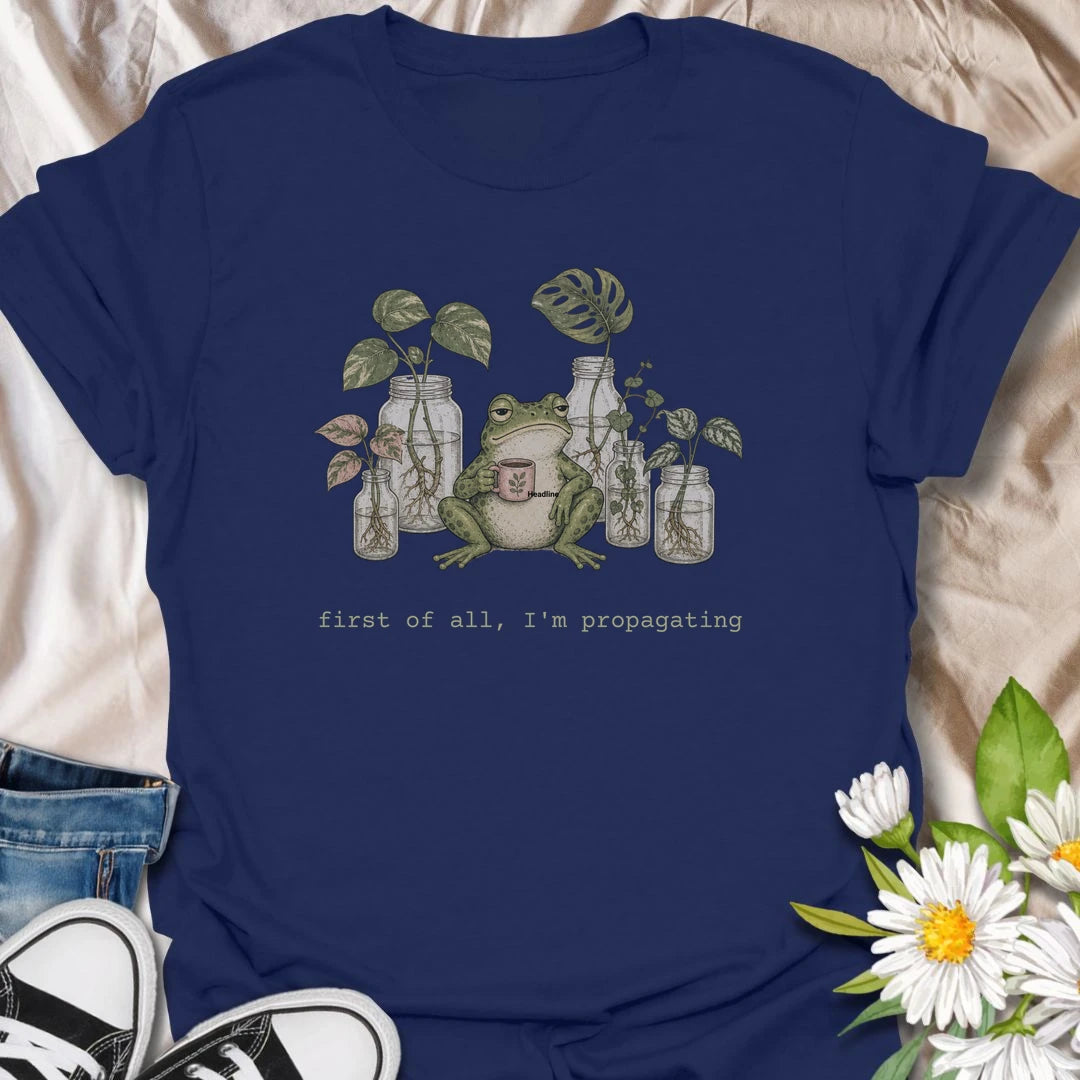 This First Of All, I’m Propagating t-shirt is perfect for plant lovers who are always snipping, rooting, and growing one more cutting. Featuring a relaxed frog holding a mug surrounded by propagation jars and trailing houseplants, this design blends cozy plant humor with a cottagecore botanical feel. Great for plant moms, plant dads, houseplant collectors, frog lovers, and anyone obsessed with propagating pothos, monstera, and indoor plants.