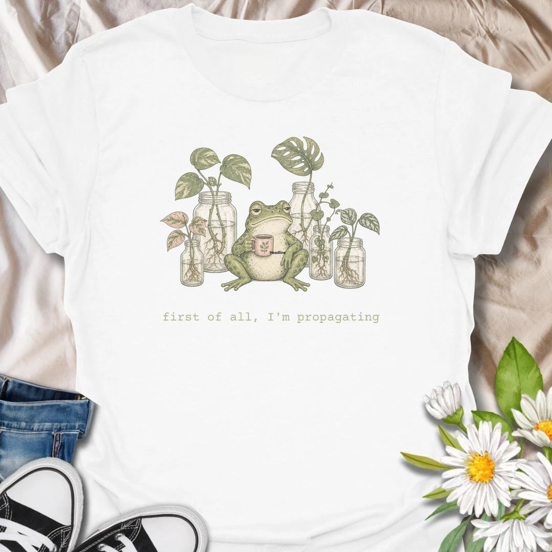 This First Of All, I’m Propagating t-shirt is perfect for plant lovers who are always snipping, rooting, and growing one more cutting. Featuring a relaxed frog holding a mug surrounded by propagation jars and trailing houseplants, this design blends cozy plant humor with a cottagecore botanical feel. Great for plant moms, plant dads, houseplant collectors, frog lovers, and anyone obsessed with propagating pothos, monstera, and indoor plants.