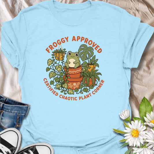 Cute frog and plant t-shirt for anyone with a certified chaotic plant corner.
Features a cheerful frog surrounded by lush houseplants and terracotta pots in a playful, giftable design.
Perfect for frog lovers, plant moms, houseplant collectors, and anyone with a slightly wild indoor jungle.