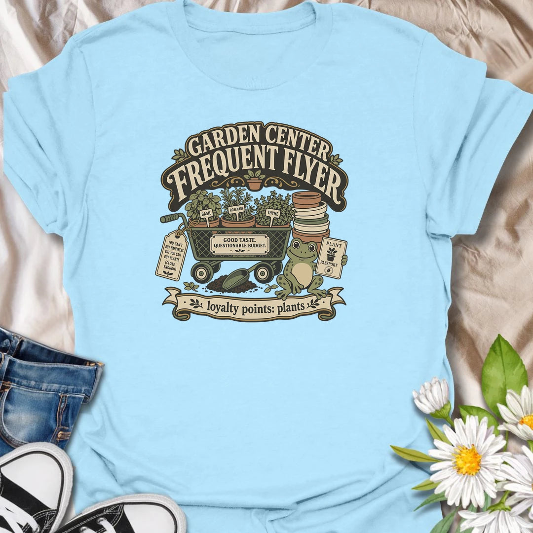 Earn imaginary loyalty points with this funny “Garden Center Frequent Flyer” T-shirt. Featuring a plant-filled cart, herb pots, garden supplies, and a cheerful frog, it is made for anyone who never leaves the nursery empty-handed. A playful gift for plant shoppers and enthusiastic gardeners.