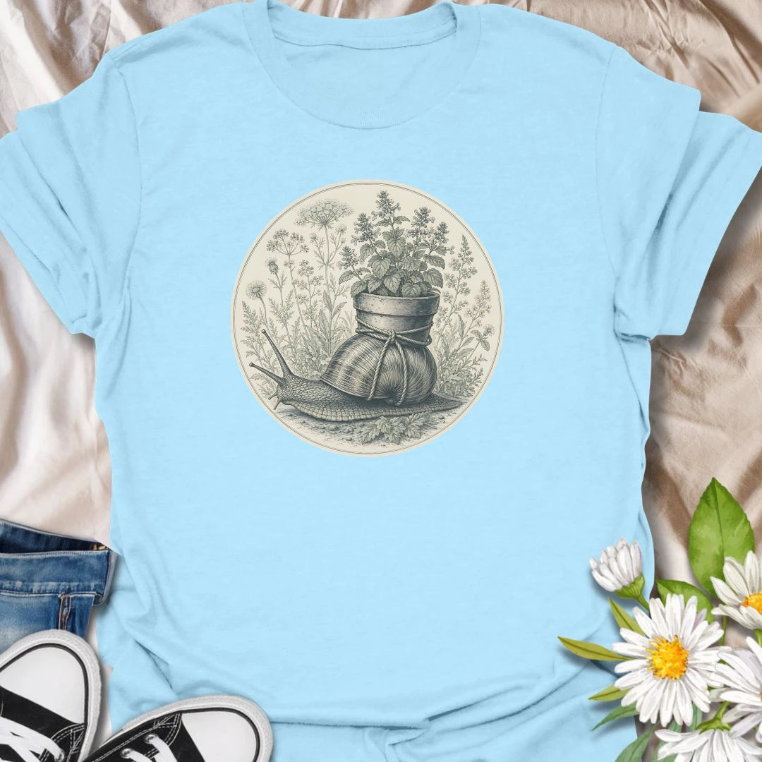 This Garden Snail With Potted Plant t-shirt is made for gardeners, plant lovers, and nature fans who enjoy soft vintage-style botanical artwork. Featuring a detailed garden snail carrying a potted plant on its shell, surrounded by wild herbs, flowers, and naturalist illustration details, this design has a gentle cottagecore feel with classic garden charm. Perfect for gardeners, snail lovers, plant moms, flower fans, botanical art lovers, and anyone who enjoys whimsical nature-inspired designs.