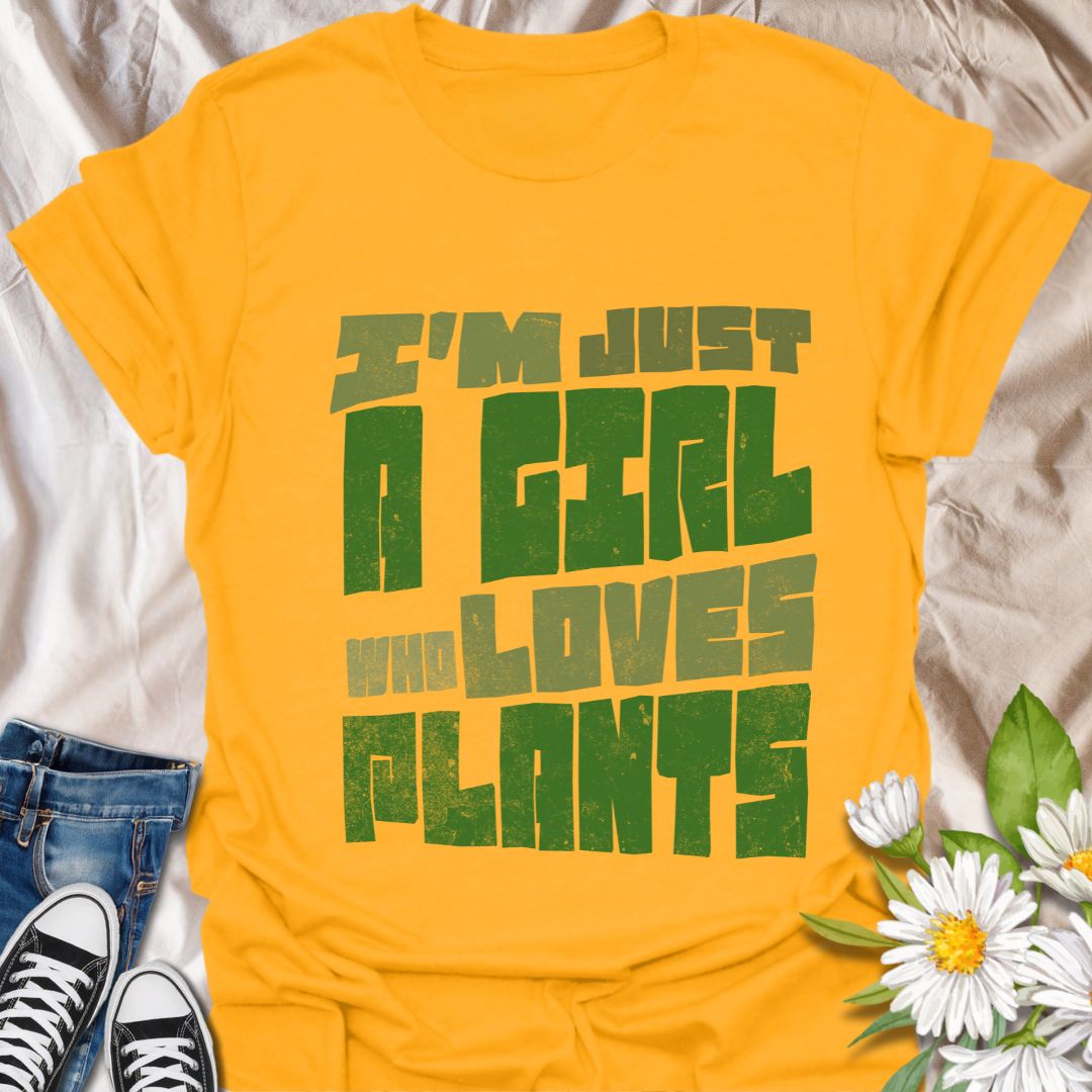 Bold statement t-shirt for plant lovers with the phrase “I’m Just a Girl Who Loves Plants” in rustic green text. Perfect gift for gardeners, plant moms, succulent fans, and nature enthusiasts who adore their indoor jungle or outdoor garden.