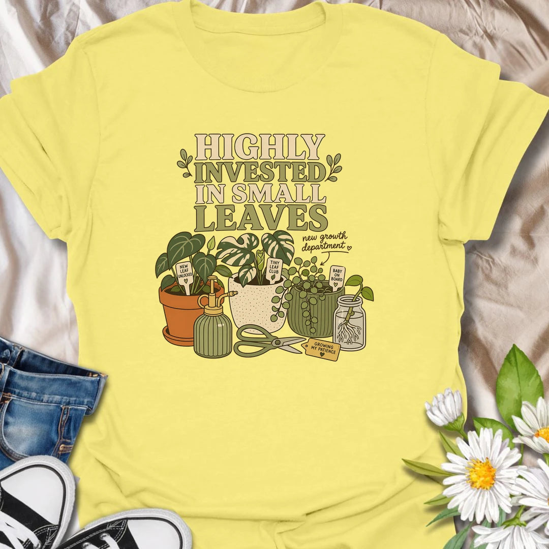 A playful plant lover T-shirt celebrating the excitement of every tiny new leaf. The design features houseplants, propagation cuttings, pruning shears, a mister, and cheerful plant markers. A thoughtful gift for plant moms, propagation enthusiasts, and anyone carefully watching for new growth.