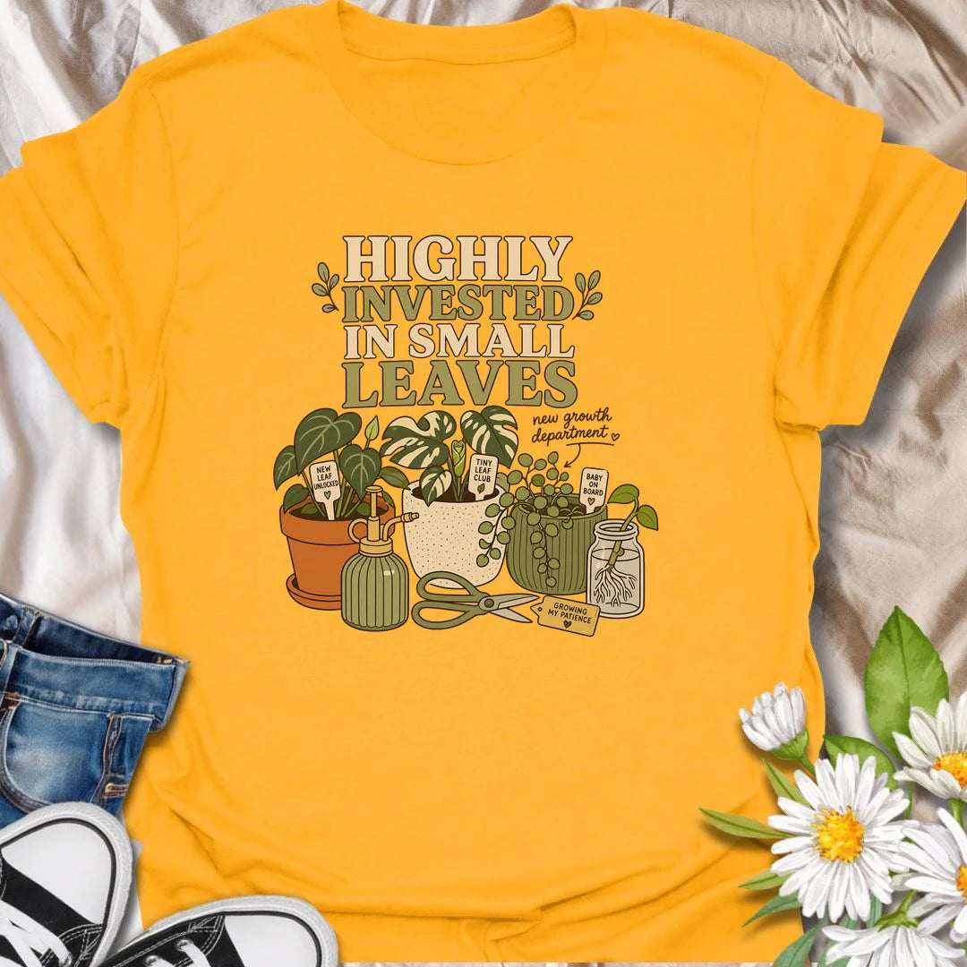 A playful plant lover T-shirt celebrating the excitement of every tiny new leaf. The design features houseplants, propagation cuttings, pruning shears, a mister, and cheerful plant markers. A thoughtful gift for plant moms, propagation enthusiasts, and anyone carefully watching for new growth.
