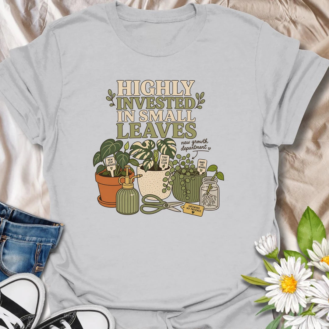 A playful plant lover T-shirt celebrating the excitement of every tiny new leaf. The design features houseplants, propagation cuttings, pruning shears, a mister, and cheerful plant markers. A thoughtful gift for plant moms, propagation enthusiasts, and anyone carefully watching for new growth.