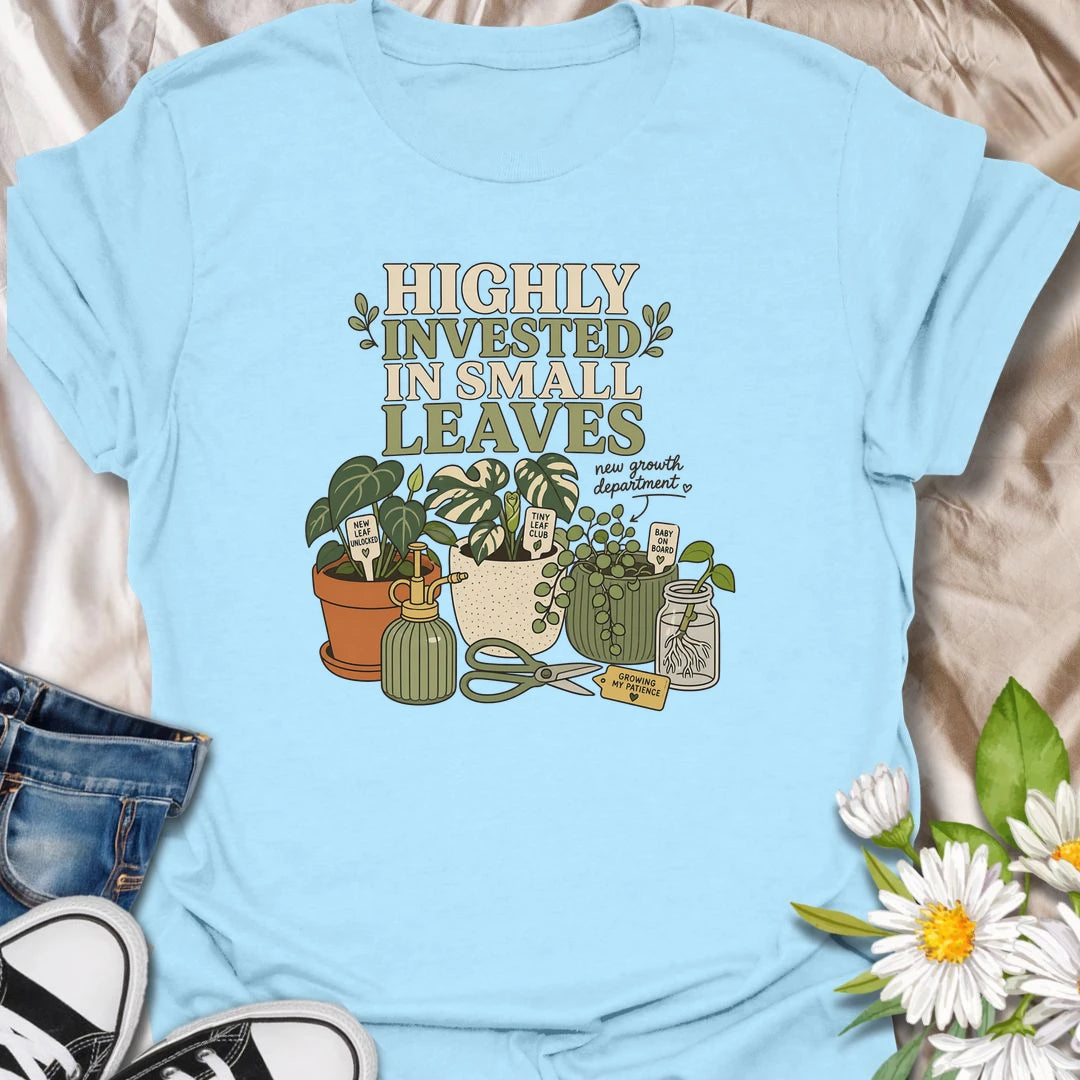 A playful plant lover T-shirt celebrating the excitement of every tiny new leaf. The design features houseplants, propagation cuttings, pruning shears, a mister, and cheerful plant markers. A thoughtful gift for plant moms, propagation enthusiasts, and anyone carefully watching for new growth.