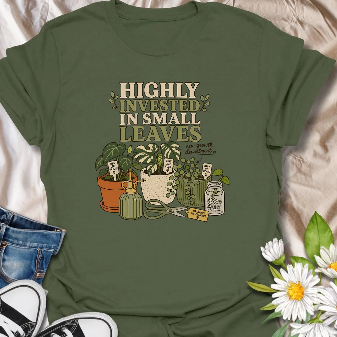 A playful plant lover T-shirt celebrating the excitement of every tiny new leaf. The design features houseplants, propagation cuttings, pruning shears, a mister, and cheerful plant markers. A thoughtful gift for plant moms, propagation enthusiasts, and anyone carefully watching for new growth.