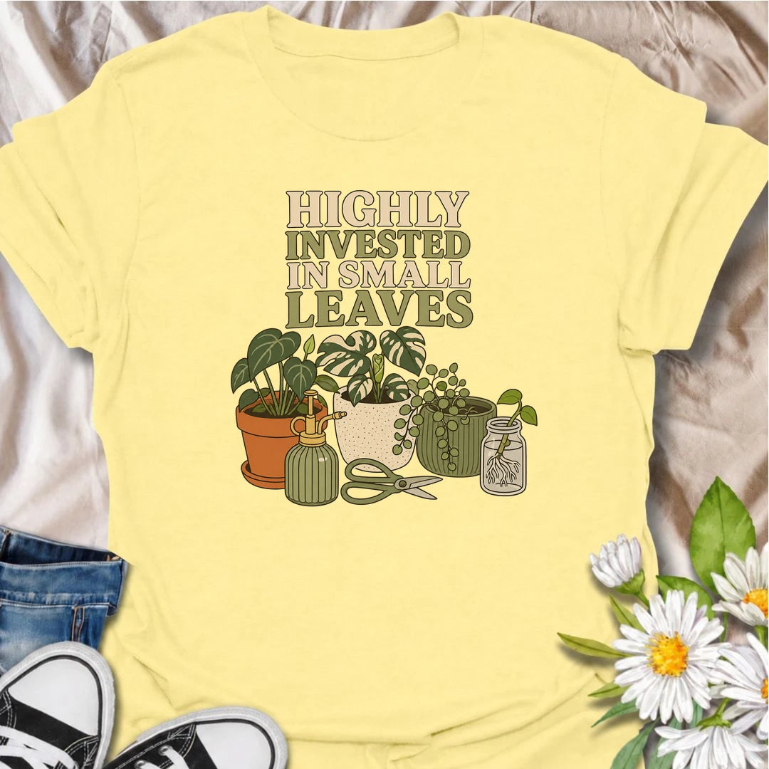 A funny houseplant T-shirt for plant lovers who are highly invested in every new leaf, cutting, and tiny bit of growth. Featuring a collection of potted plants, propagation supplies, and gardening tools, this design is perfect for dedicated plant parents and indoor gardeners. The “Highly Invested in Small Leaves” phrase captures the slightly obsessive joy of watching houseplants grow. It makes a great gift for pothos lovers, propagation fans, and anyone building their own indoor jungle. A relaxed botanical 