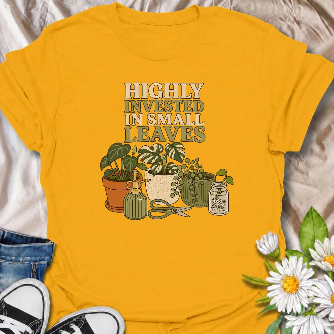 A funny houseplant T-shirt for plant lovers who are highly invested in every new leaf, cutting, and tiny bit of growth. Featuring a collection of potted plants, propagation supplies, and gardening tools, this design is perfect for dedicated plant parents and indoor gardeners. The “Highly Invested in Small Leaves” phrase captures the slightly obsessive joy of watching houseplants grow. It makes a great gift for pothos lovers, propagation fans, and anyone building their own indoor jungle. A relaxed botanical 