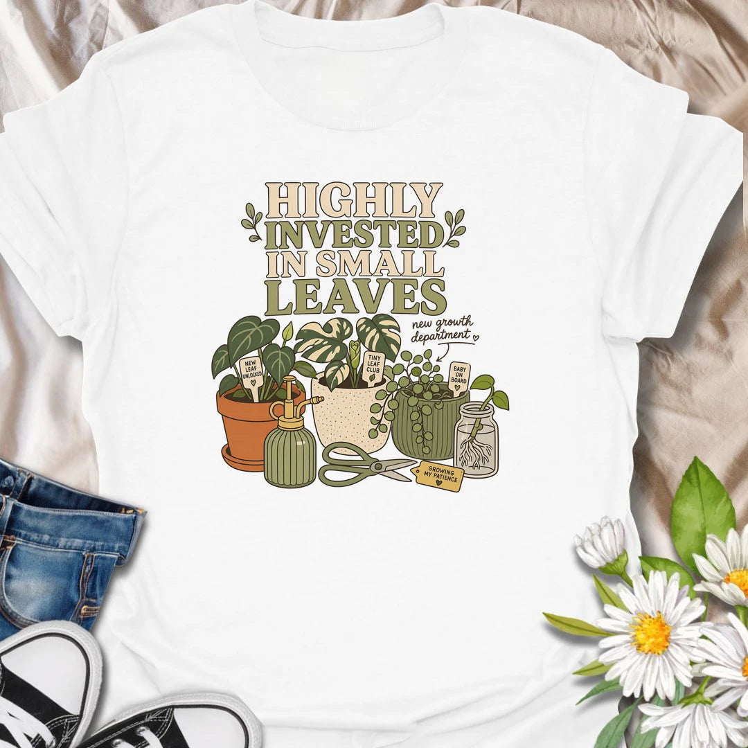 A playful plant lover T-shirt celebrating the excitement of every tiny new leaf. The design features houseplants, propagation cuttings, pruning shears, a mister, and cheerful plant markers. A thoughtful gift for plant moms, propagation enthusiasts, and anyone carefully watching for new growth.