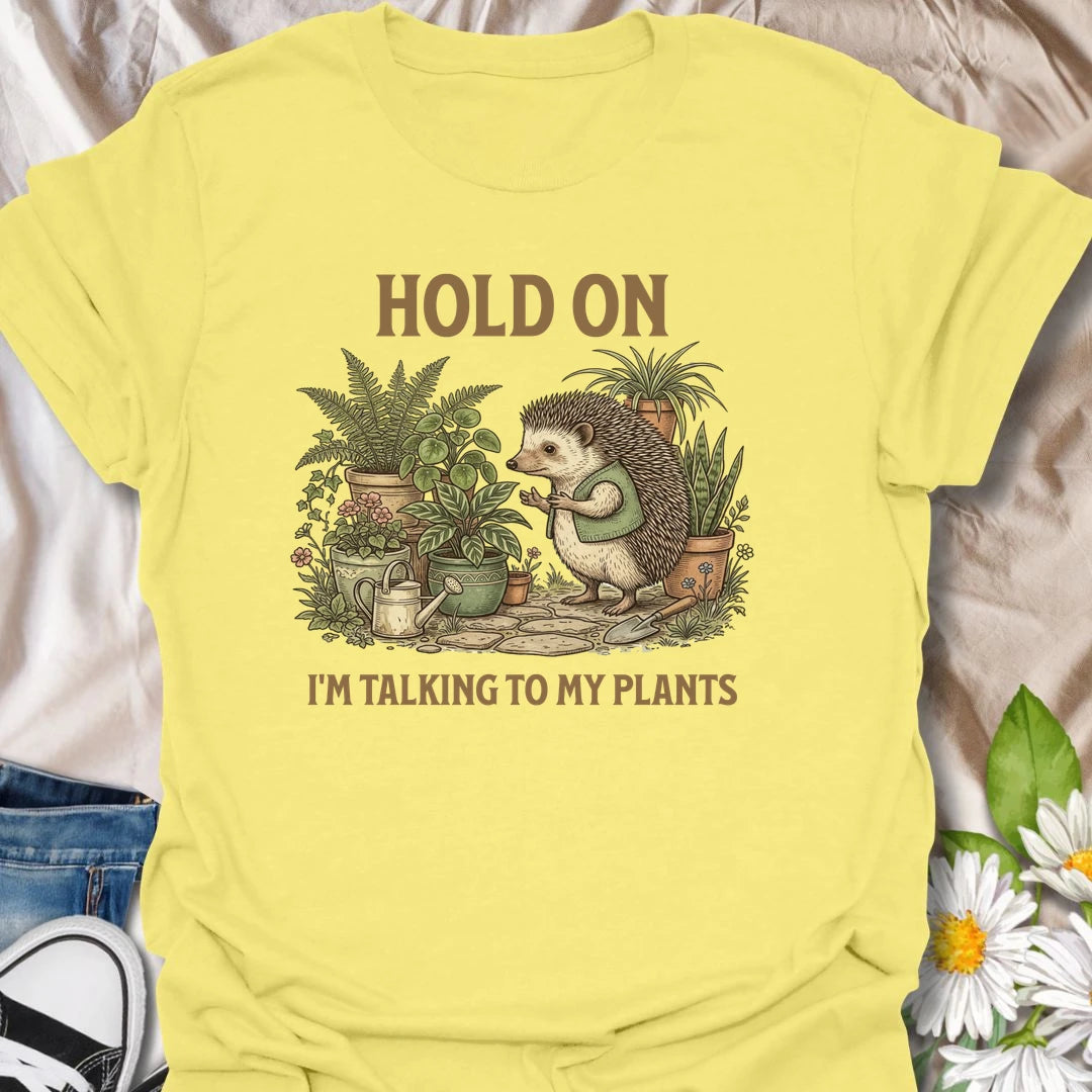 This Hold On I’m Talking To My Plants t-shirt is perfect for plant lovers who know houseplants deserve attention before people do. Featuring a cozy hedgehog chatting to potted plants in a lush botanical scene, this funny gardening design is great for plant moms, plant dads, houseplant collectors, indoor gardeners, nature lovers, and anyone who happily talks to their plants.