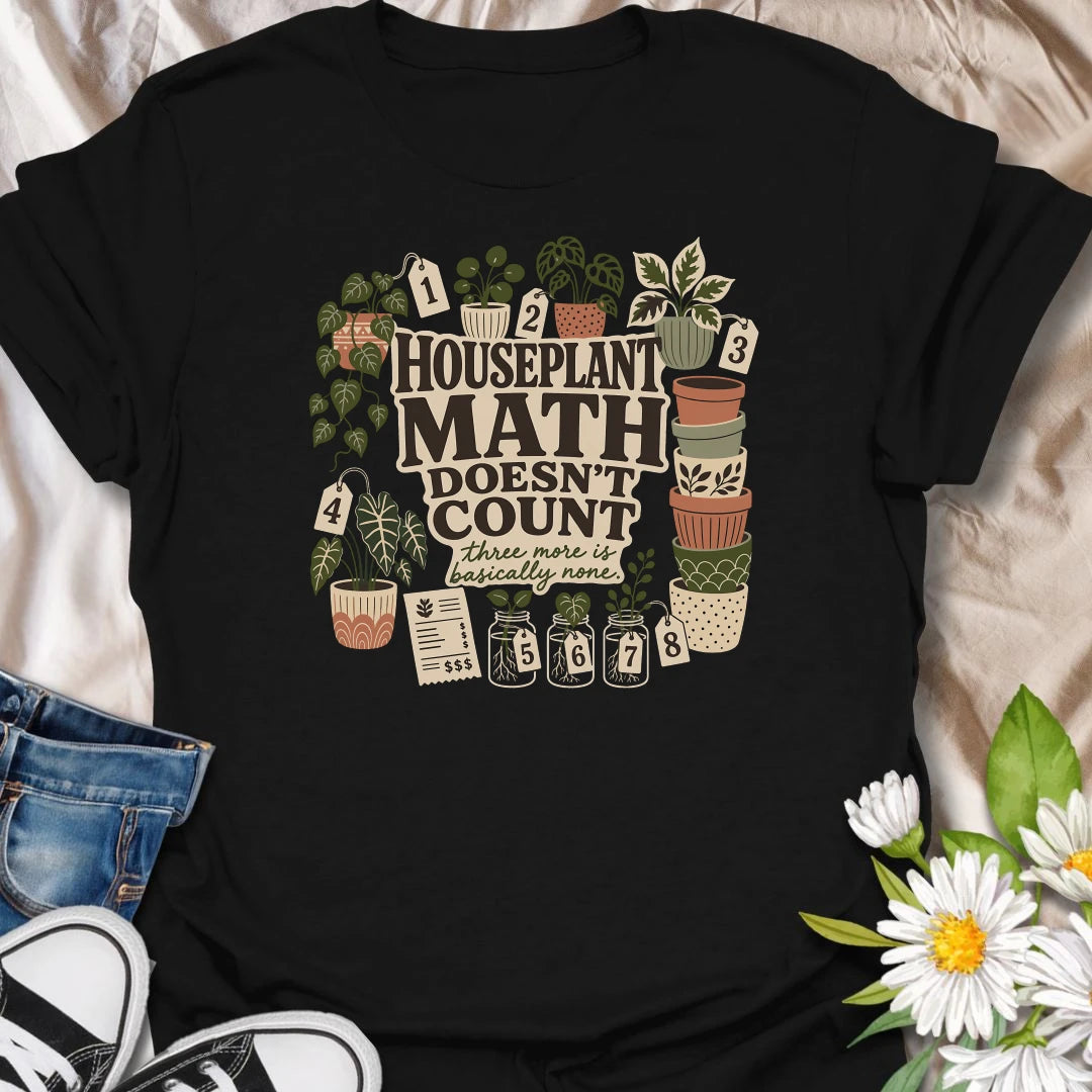 Plant numbers are always negotiable with this “Houseplant Math Doesn’t Count” T-shirt. Surrounded by numbered plants, decorative pots, cuttings, and a suspiciously long receipt, the design is perfect for enthusiastic indoor gardeners. It makes a funny gift for plant collectors who believe three more is basically none.