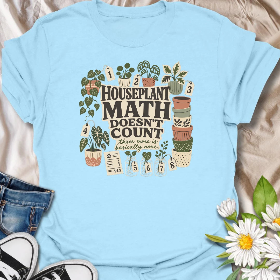 Plant numbers are always negotiable with this “Houseplant Math Doesn’t Count” T-shirt. Surrounded by numbered plants, decorative pots, cuttings, and a suspiciously long receipt, the design is perfect for enthusiastic indoor gardeners. It makes a funny gift for plant collectors who believe three more is basically none.