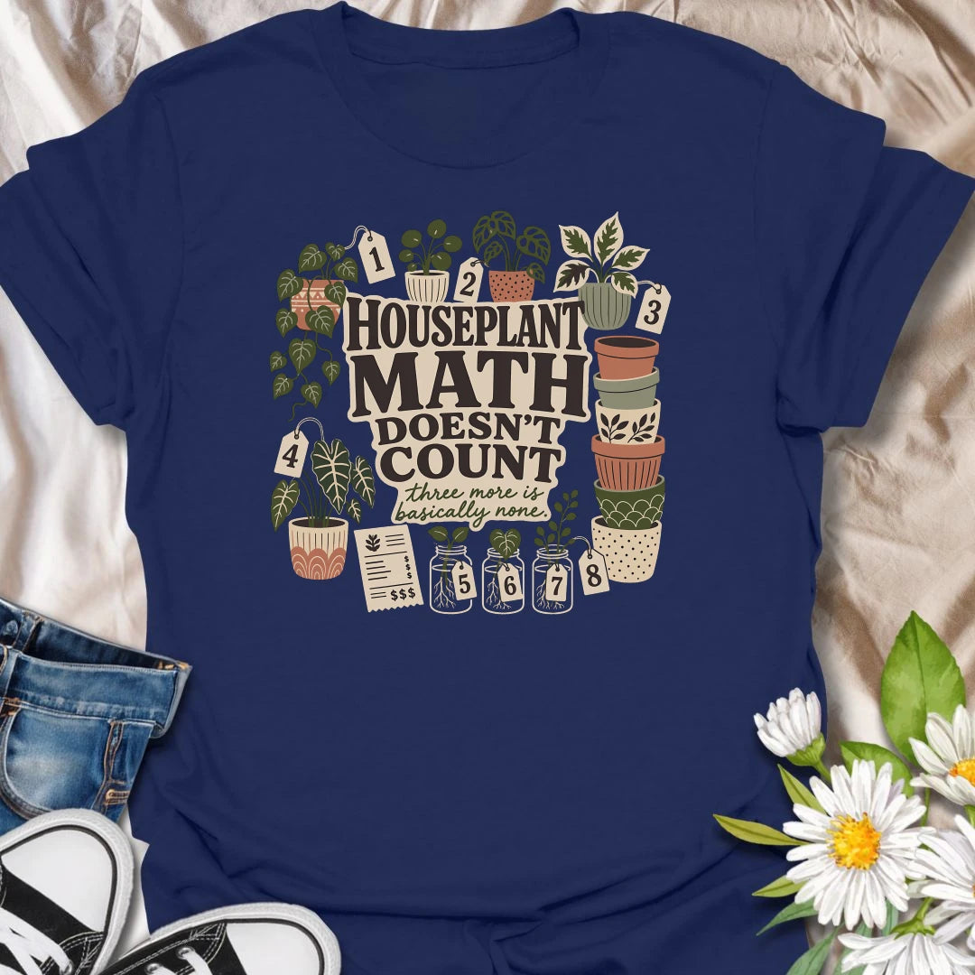 Plant numbers are always negotiable with this “Houseplant Math Doesn’t Count” T-shirt. Surrounded by numbered plants, decorative pots, cuttings, and a suspiciously long receipt, the design is perfect for enthusiastic indoor gardeners. It makes a funny gift for plant collectors who believe three more is basically none.