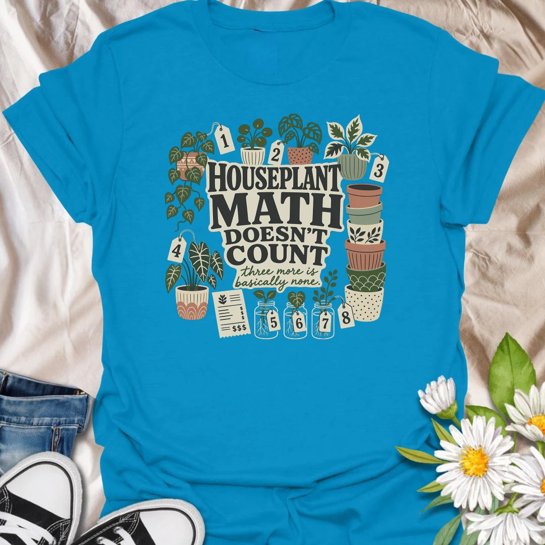 Plant numbers are always negotiable with this “Houseplant Math Doesn’t Count” T-shirt. Surrounded by numbered plants, decorative pots, cuttings, and a suspiciously long receipt, the design is perfect for enthusiastic indoor gardeners. It makes a funny gift for plant collectors who believe three more is basically none.