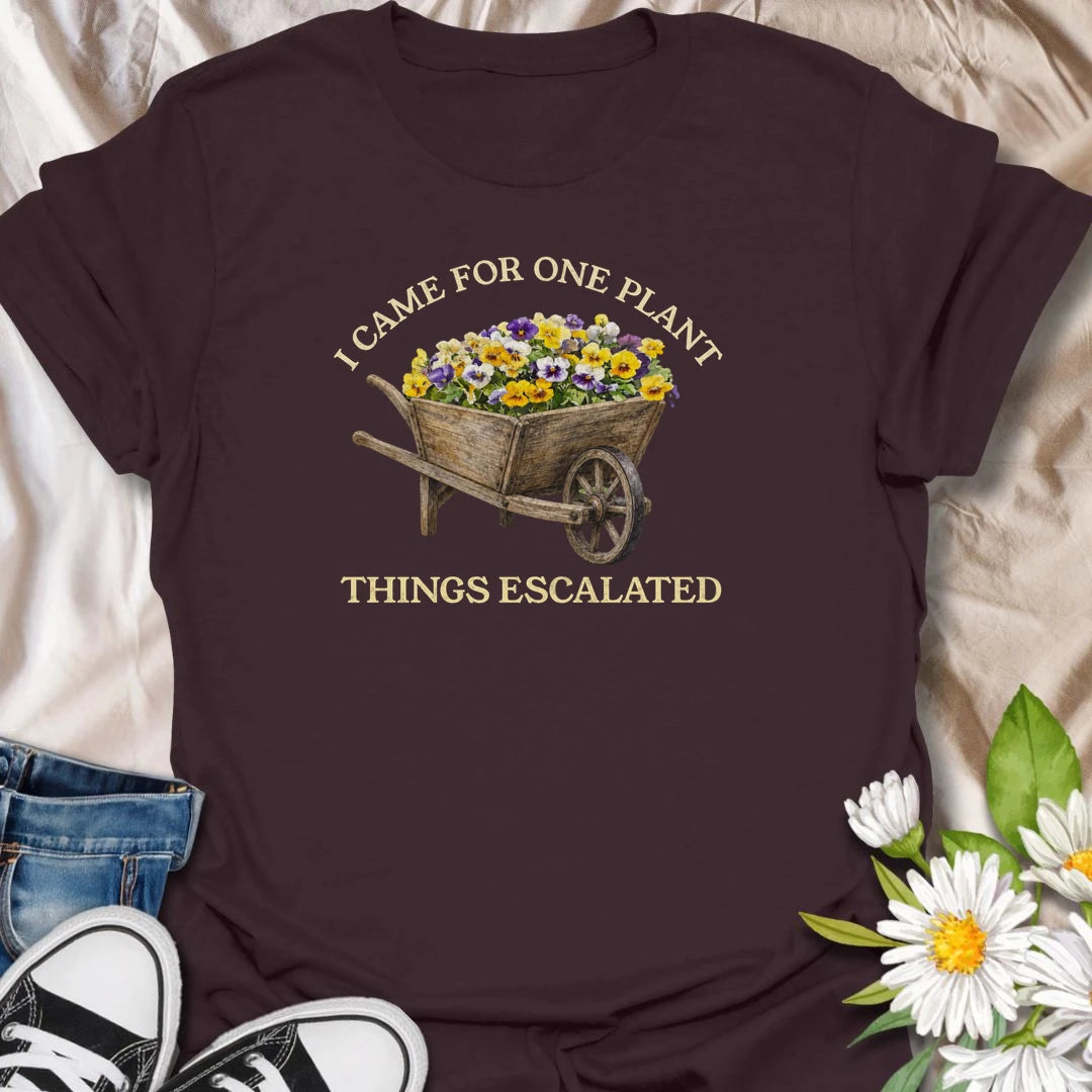 This I Came For One Plant Things Escalated t-shirt is perfect for plant lovers who know a quick trip to the nursery can easily turn into a full wheelbarrow of flowers. Featuring a rustic wooden wheelbarrow overflowing with colorful blooms and bold vintage-style text, this funny botanical design is great for gardeners, plant moms, flower lovers, nursery shoppers, and anyone who never really leaves with just one plant.