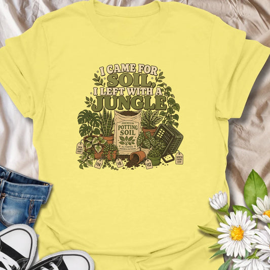 Celebrate an accidental plant haul with this “I Came for Soil, I Left With a Jungle” T-shirt. Featuring a bag of potting soil surrounded by lush houseplants and price tags, it is perfect for devoted plant shoppers. A funny gift for anyone whose quick nursery visit becomes a full indoor jungle.