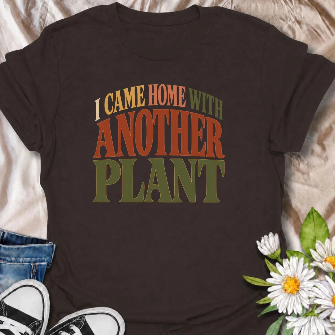 A funny plant T-shirt for anyone who leaves the house with no intention of buying a plant and comes home with one anyway. The phrase “I Came Home With Another Plant” is instantly relatable for houseplant lovers, nursery regulars, and enthusiastic plant collectors. Its bold retro typography keeps the design simple, readable, and easy to wear. It makes a great gift for plant parents, indoor gardeners, and anyone whose collection keeps growing one unexpected purchase at a time. Ideal for nursery trips, plant s