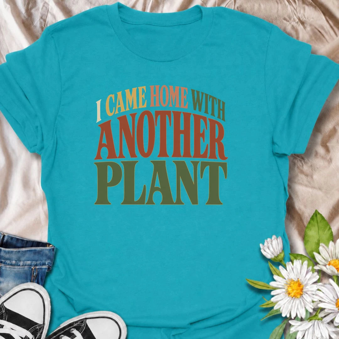 A funny plant T-shirt for anyone who leaves the house with no intention of buying a plant and comes home with one anyway. The phrase “I Came Home With Another Plant” is instantly relatable for houseplant lovers, nursery regulars, and enthusiastic plant collectors. Its bold retro typography keeps the design simple, readable, and easy to wear. It makes a great gift for plant parents, indoor gardeners, and anyone whose collection keeps growing one unexpected purchase at a time. Ideal for nursery trips, plant s