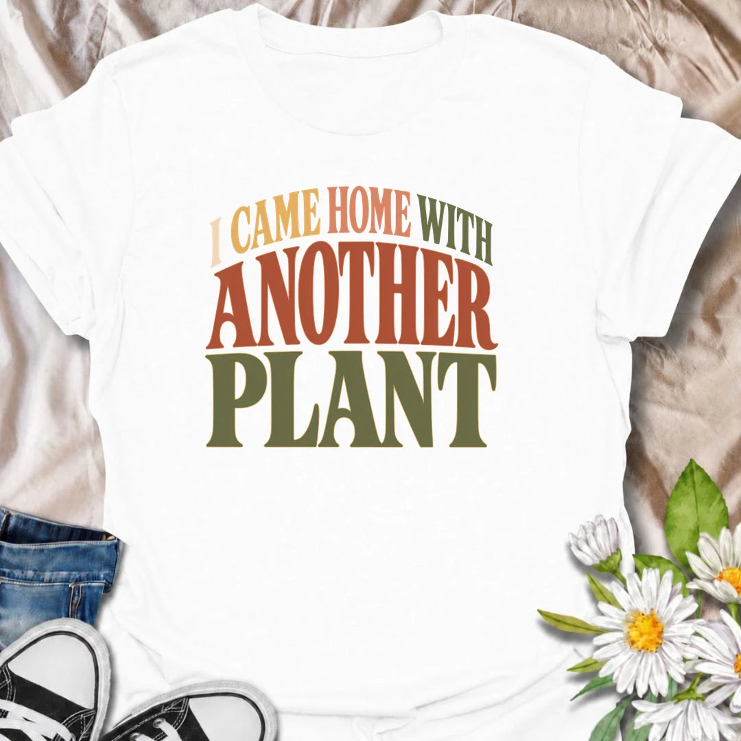 A funny plant T-shirt for anyone who leaves the house with no intention of buying a plant and comes home with one anyway. The phrase “I Came Home With Another Plant” is instantly relatable for houseplant lovers, nursery regulars, and enthusiastic plant collectors. Its bold retro typography keeps the design simple, readable, and easy to wear. It makes a great gift for plant parents, indoor gardeners, and anyone whose collection keeps growing one unexpected purchase at a time. Ideal for nursery trips, plant s