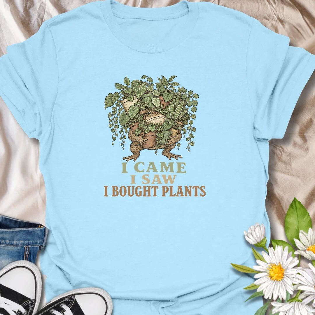 This I Came I Saw I Bought Plants t-shirt is perfect for plant lovers who never leave the nursery, garden center, or plant shop empty-handed. Featuring a determined frog carrying an armful of leafy houseplants, this funny botanical design is great for plant moms, plant dads, houseplant collectors, indoor gardeners, and anyone who always comes home with more plants.