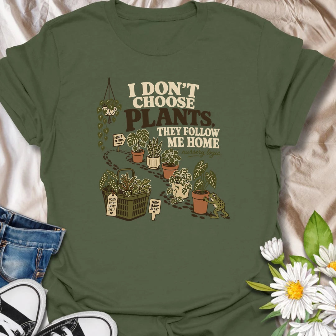 A funny houseplant T-shirt for anyone who never intends to buy another plant but somehow does. The design features a trail of potted plants, a full shopping basket, and a playful frog helping another plant come home. A perfect gift for nursery shoppers, plant collectors, and proud plant parents.