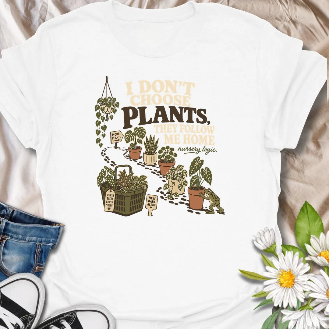 A funny houseplant T-shirt for anyone who never intends to buy another plant but somehow does. The design features a trail of potted plants, a full shopping basket, and a playful frog helping another plant come home. A perfect gift for nursery shoppers, plant collectors, and proud plant parents.