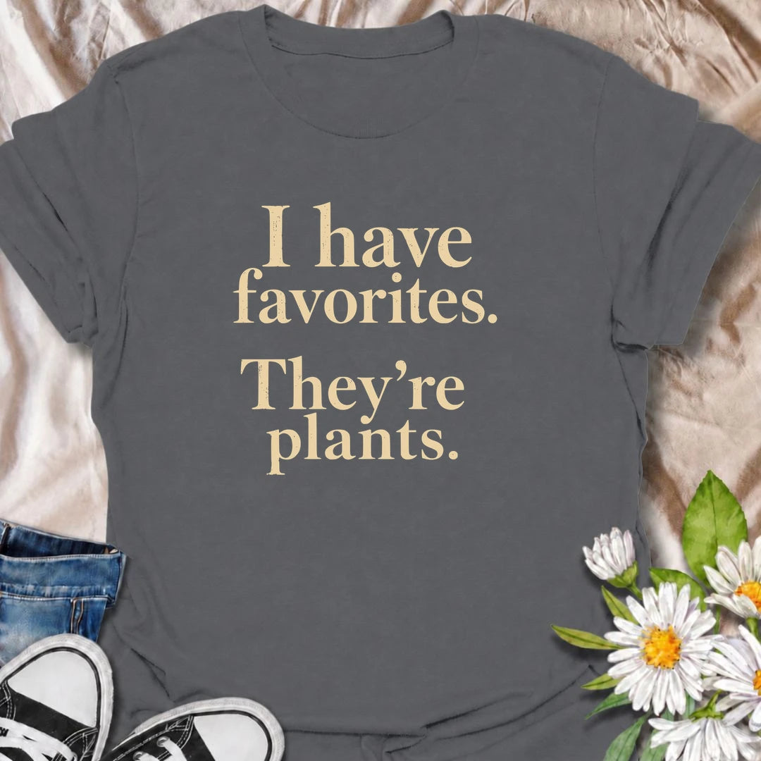 A funny plant T-shirt for anyone who definitely has favorites—and they happen to be plants. The phrase “I Have Favorites. They’re Plants.” delivers simple, dry humor that houseplant lovers and plant collectors will instantly relate to. Perfect for plant parents, indoor gardeners, and anyone who would happily choose a nursery trip over most social plans. The clean typography makes it easy to wear while still feeling niche and personality-driven. A great gift for pothos fans, plant ladies, and anyone building