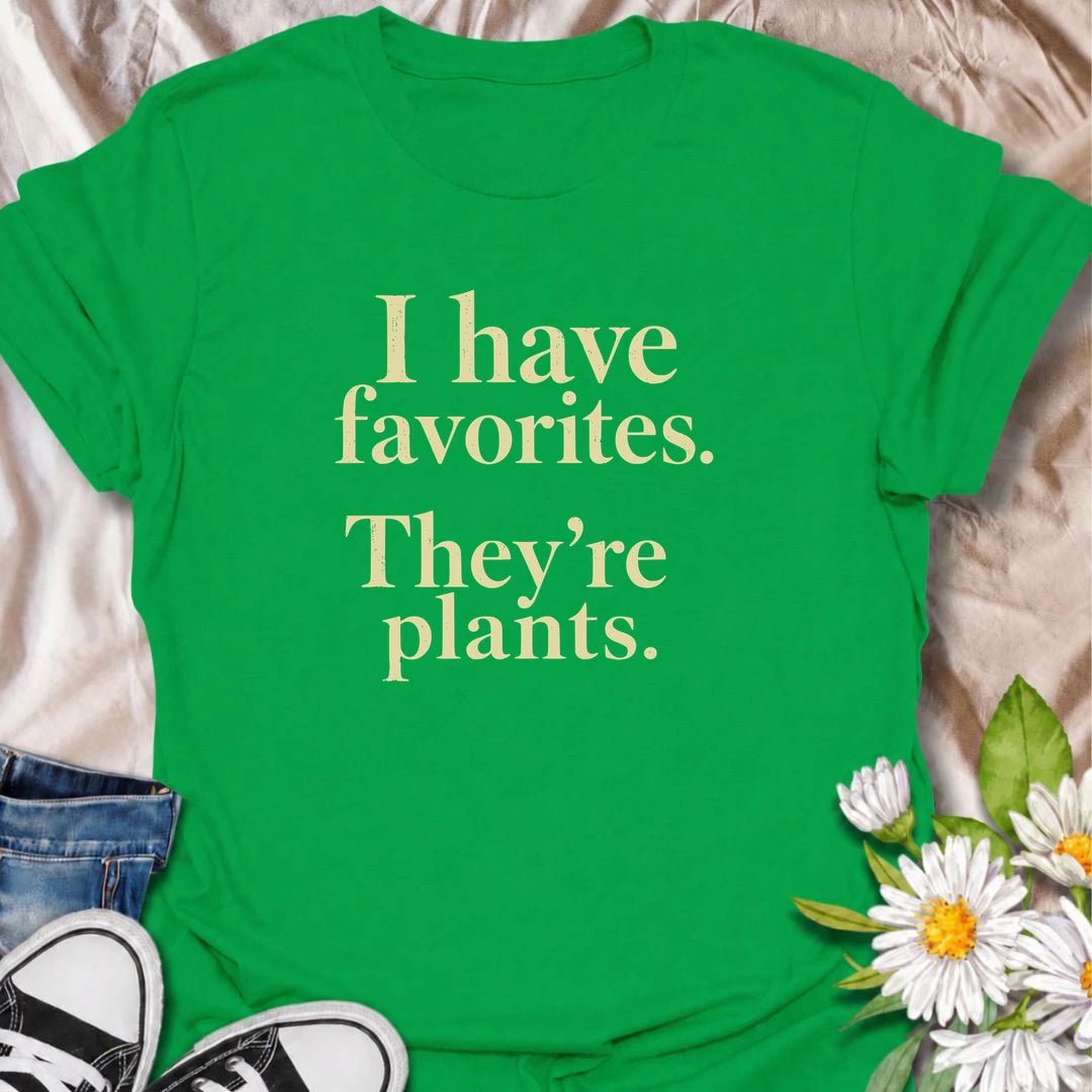 A funny plant T-shirt for anyone who definitely has favorites—and they happen to be plants. The phrase “I Have Favorites. They’re Plants.” delivers simple, dry humor that houseplant lovers and plant collectors will instantly relate to. Perfect for plant parents, indoor gardeners, and anyone who would happily choose a nursery trip over most social plans. The clean typography makes it easy to wear while still feeling niche and personality-driven. A great gift for pothos fans, plant ladies, and anyone building