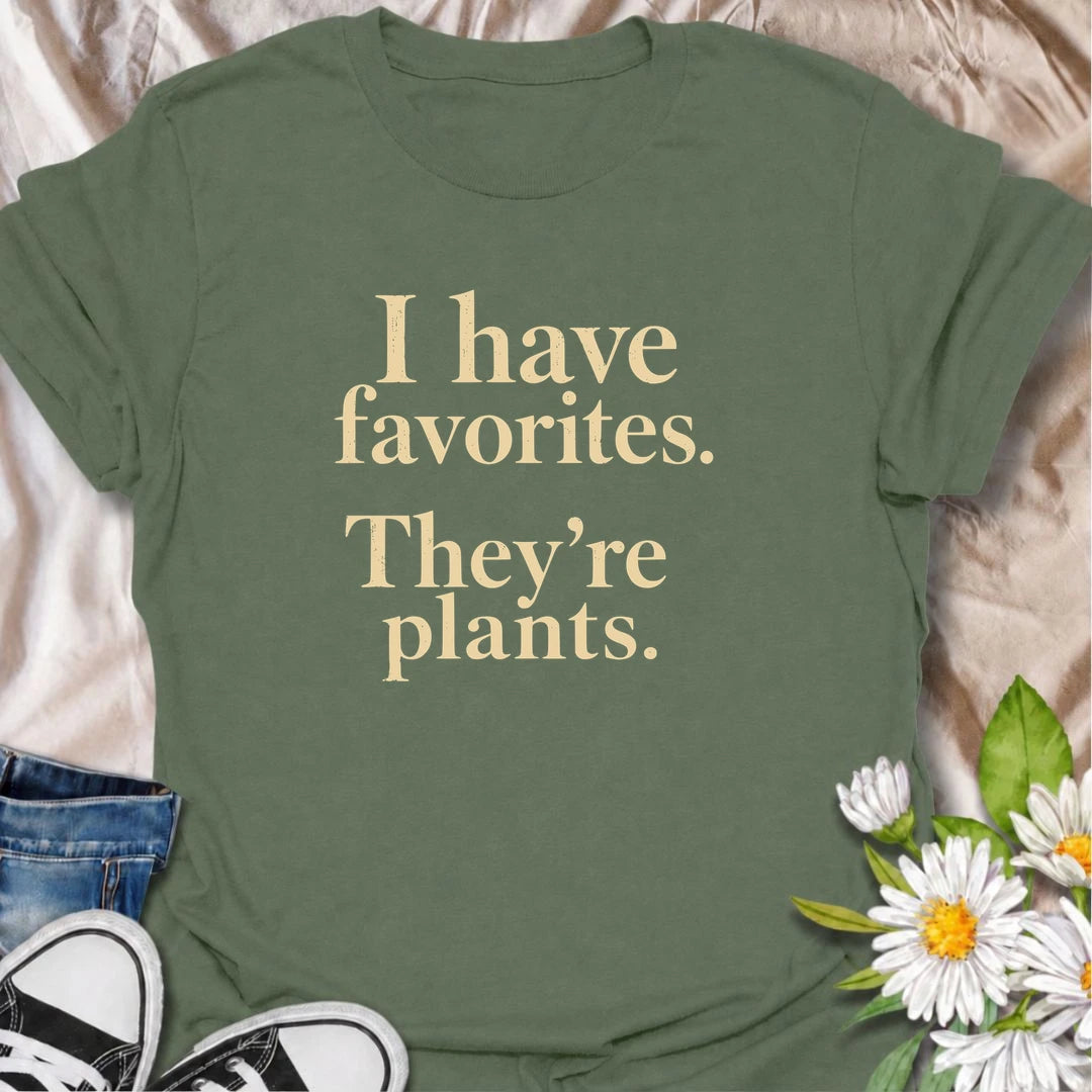 A funny plant T-shirt for anyone who definitely has favorites—and they happen to be plants. The phrase “I Have Favorites. They’re Plants.” delivers simple, dry humor that houseplant lovers and plant collectors will instantly relate to. Perfect for plant parents, indoor gardeners, and anyone who would happily choose a nursery trip over most social plans. The clean typography makes it easy to wear while still feeling niche and personality-driven. A great gift for pothos fans, plant ladies, and anyone building