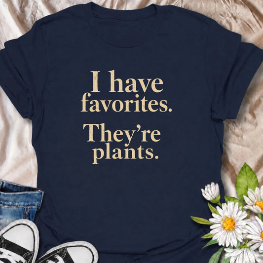 A funny plant T-shirt for anyone who definitely has favorites—and they happen to be plants. The phrase “I Have Favorites. They’re Plants.” delivers simple, dry humor that houseplant lovers and plant collectors will instantly relate to. Perfect for plant parents, indoor gardeners, and anyone who would happily choose a nursery trip over most social plans. The clean typography makes it easy to wear while still feeling niche and personality-driven. A great gift for pothos fans, plant ladies, and anyone building