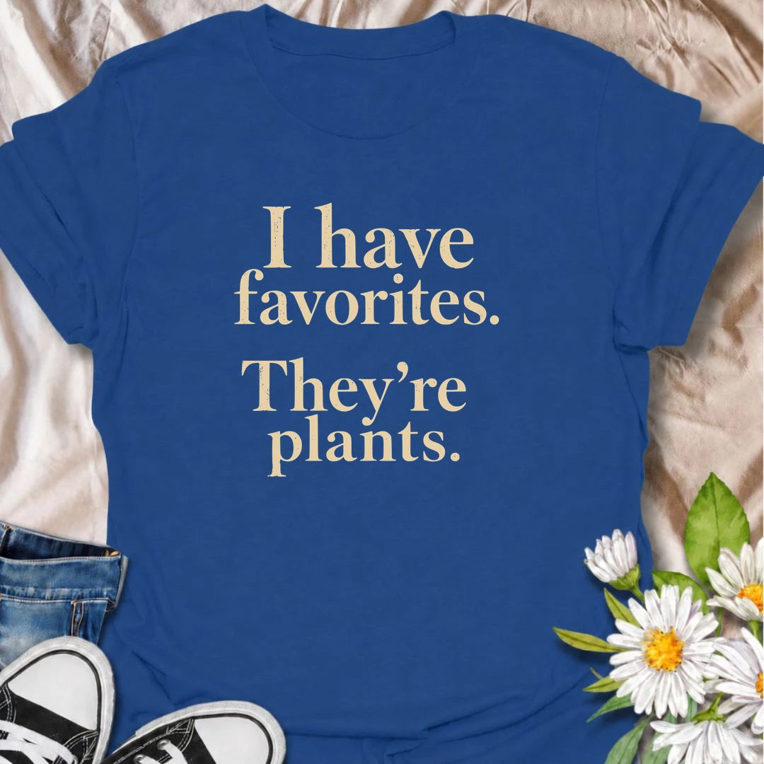 A funny plant T-shirt for anyone who definitely has favorites—and they happen to be plants. The phrase “I Have Favorites. They’re Plants.” delivers simple, dry humor that houseplant lovers and plant collectors will instantly relate to. Perfect for plant parents, indoor gardeners, and anyone who would happily choose a nursery trip over most social plans. The clean typography makes it easy to wear while still feeling niche and personality-driven. A great gift for pothos fans, plant ladies, and anyone building
