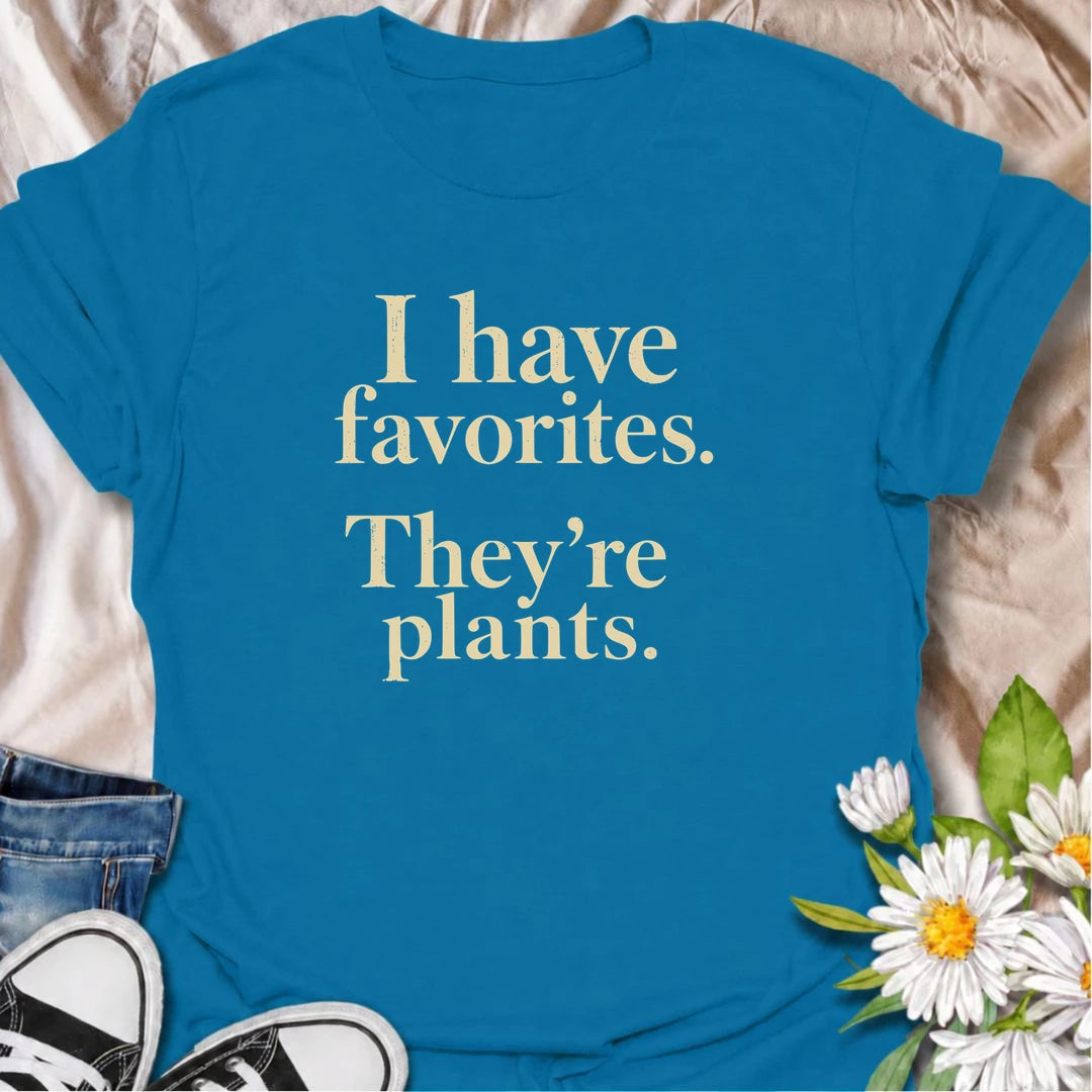 A funny plant T-shirt for anyone who definitely has favorites—and they happen to be plants. The phrase “I Have Favorites. They’re Plants.” delivers simple, dry humor that houseplant lovers and plant collectors will instantly relate to. Perfect for plant parents, indoor gardeners, and anyone who would happily choose a nursery trip over most social plans. The clean typography makes it easy to wear while still feeling niche and personality-driven. A great gift for pothos fans, plant ladies, and anyone building