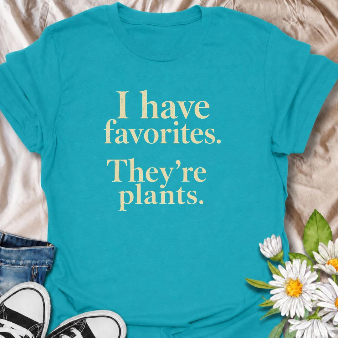 A funny plant T-shirt for anyone who definitely has favorites—and they happen to be plants. The phrase “I Have Favorites. They’re Plants.” delivers simple, dry humor that houseplant lovers and plant collectors will instantly relate to. Perfect for plant parents, indoor gardeners, and anyone who would happily choose a nursery trip over most social plans. The clean typography makes it easy to wear while still feeling niche and personality-driven. A great gift for pothos fans, plant ladies, and anyone building