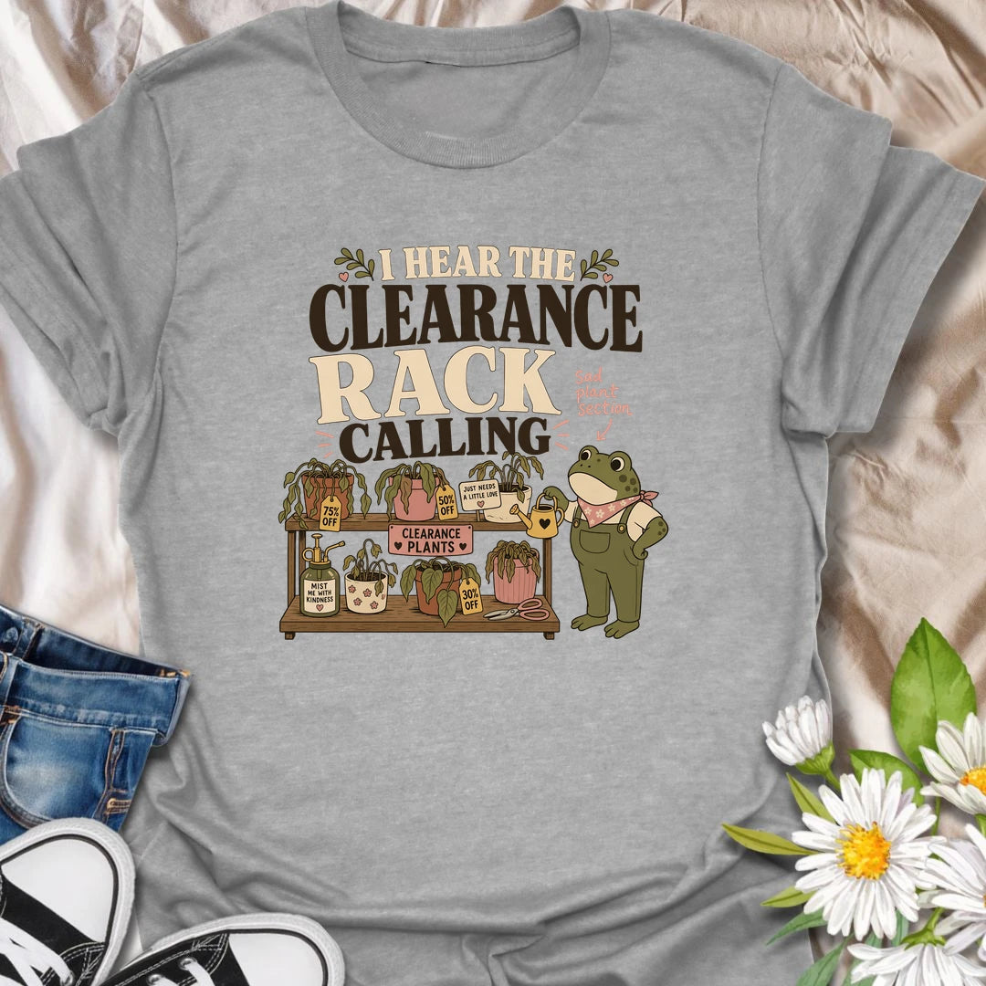 A funny plant rescue T-shirt for anyone unable to walk past the clearance section. The design features a helpful frog tending a collection of slightly sad discounted plants. A charming gift for bargain plant shoppers, plant rescuers, and anyone convinced every neglected houseplant deserves another chance.