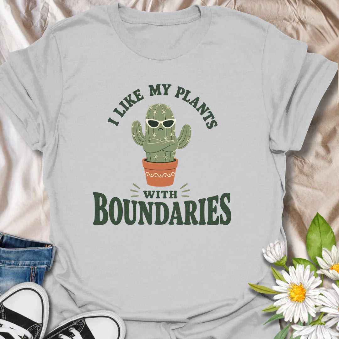 This I Like My Plants With Boundaries t-shirt is made for cactus lovers, succulent fans, and plant people with a sarcastic sense of humor. Featuring a grumpy potted cactus in sunglasses with crossed arms and bold retro lettering, this design has a funny low-maintenance plant vibe with plenty of attitude. Perfect for cactus lovers, plant moms, plant dads, succulent collectors, introverts, and anyone who appreciates plants with strong personal boundaries.