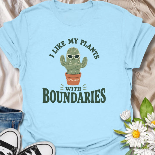 This I Like My Plants With Boundaries t-shirt is made for cactus lovers, succulent fans, and plant people with a sarcastic sense of humor. Featuring a grumpy potted cactus in sunglasses with crossed arms and bold retro lettering, this design has a funny low-maintenance plant vibe with plenty of attitude. Perfect for cactus lovers, plant moms, plant dads, succulent collectors, introverts, and anyone who appreciates plants with strong personal boundaries.