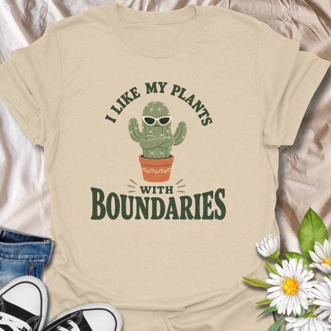 This I Like My Plants With Boundaries t-shirt is made for cactus lovers, succulent fans, and plant people with a sarcastic sense of humor. Featuring a grumpy potted cactus in sunglasses with crossed arms and bold retro lettering, this design has a funny low-maintenance plant vibe with plenty of attitude. Perfect for cactus lovers, plant moms, plant dads, succulent collectors, introverts, and anyone who appreciates plants with strong personal boundaries.Sand
