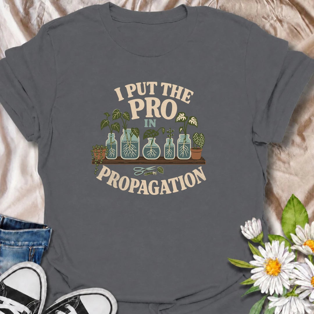 A funny propagation T-shirt for houseplant lovers who have turned rooting cuttings into a full-time hobby. Featuring plant cuttings growing in water-filled jars, this design is made for pothos fans, plant parents, and indoor gardeners. The playful “I Put the Pro in Propagation” phrase makes it a great gift for anyone with a growing collection of propagated plants. Perfect for plant swaps, nursery trips, greenhouse days, or simply showing off your houseplant obsession. A fun botanical graphic tee for anyone 