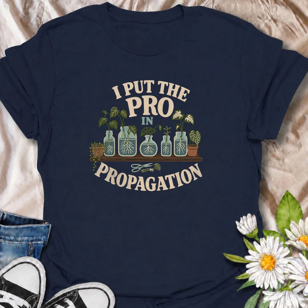A funny propagation T-shirt for houseplant lovers who have turned rooting cuttings into a full-time hobby. Featuring plant cuttings growing in water-filled jars, this design is made for pothos fans, plant parents, and indoor gardeners. The playful “I Put the Pro in Propagation” phrase makes it a great gift for anyone with a growing collection of propagated plants. Perfect for plant swaps, nursery trips, greenhouse days, or simply showing off your houseplant obsession. A fun botanical graphic tee for anyone 
